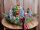 Karácsonyi asztaldísz csónak alakú kaspóban, Grincs figurával és LED lámpákkal
